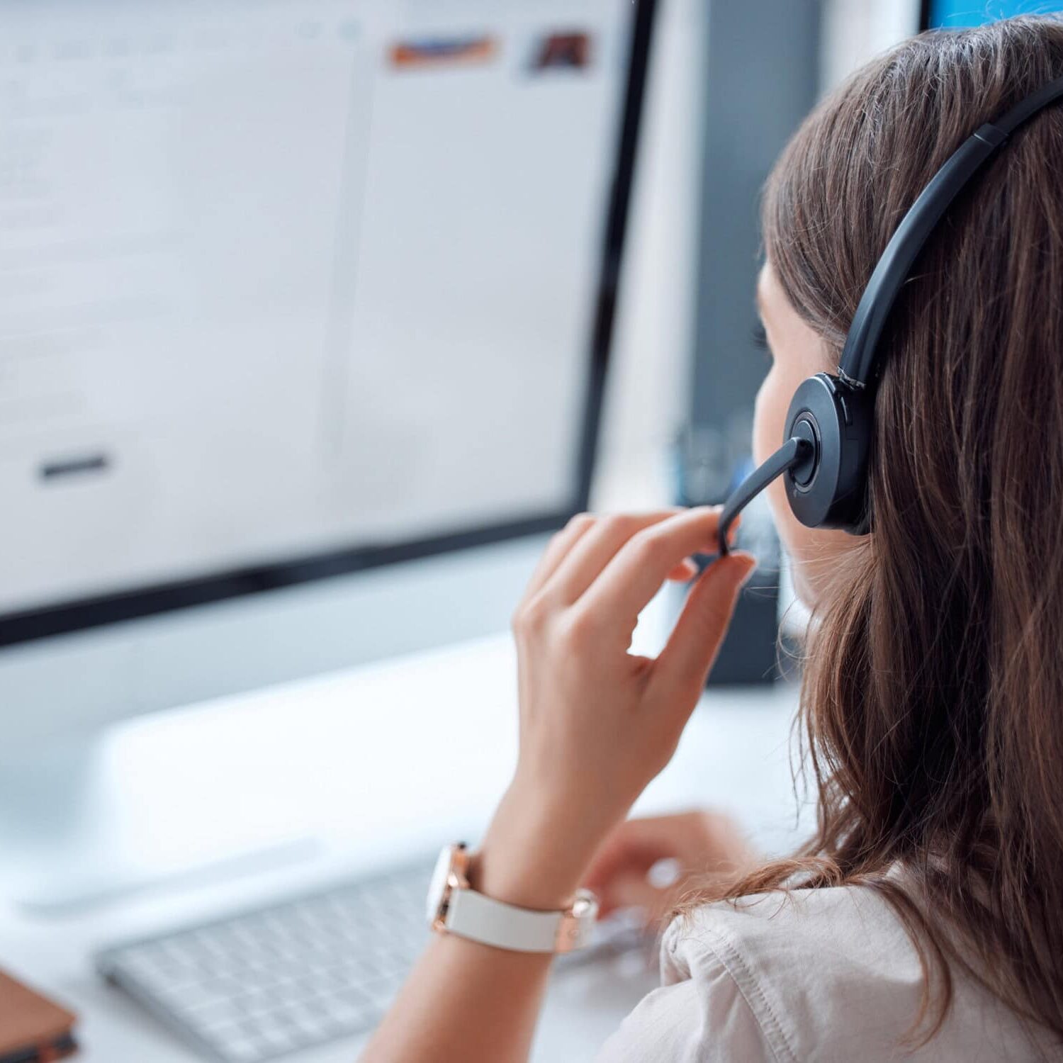 Customer support, call center or answering service and back of female agent working on online consultation in the office. Answering service , communication planning crm with headset and computer in workplace
