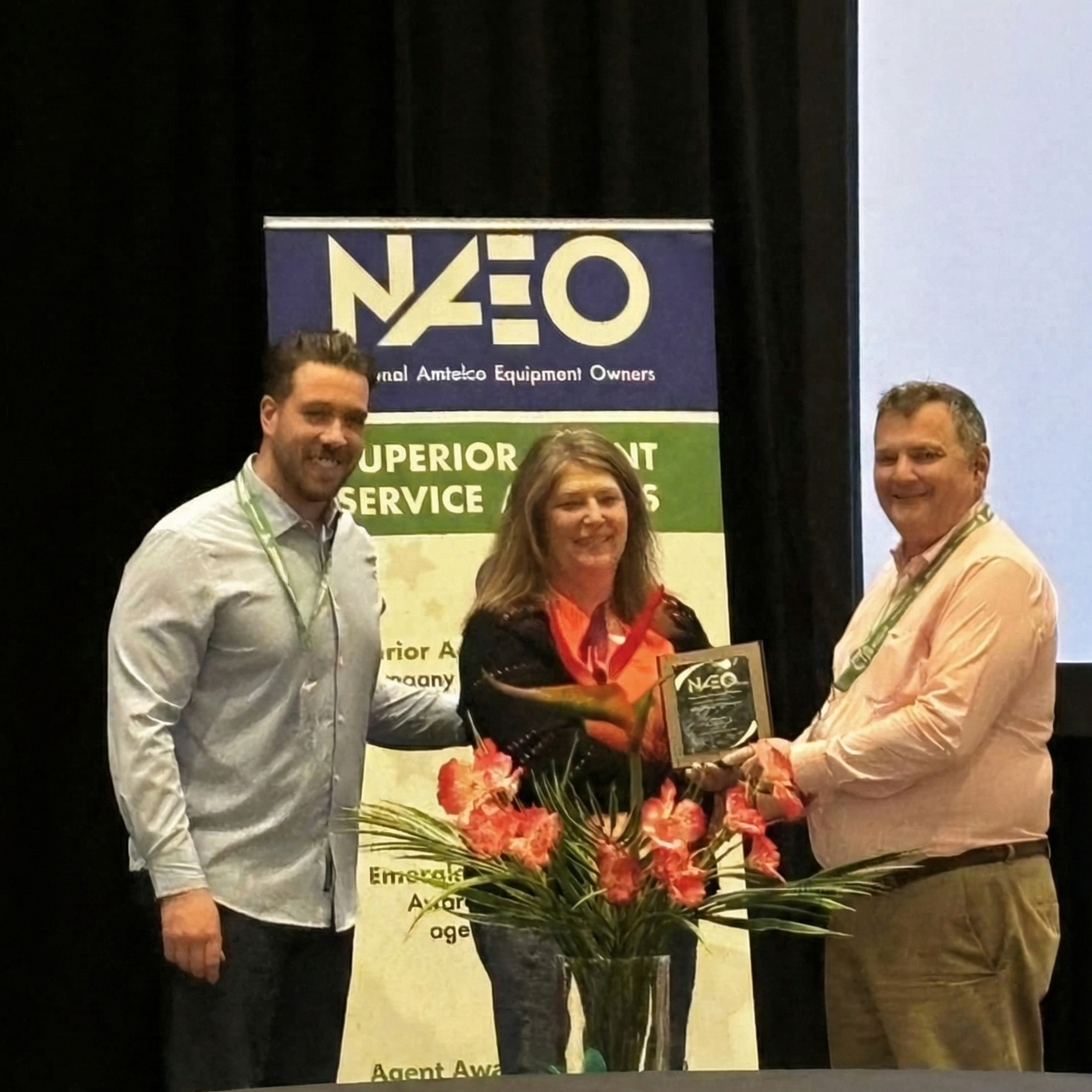 Dan and Kelly with Alliance Answer accepting their award for winning the 2025 NAEO Superior Agent Service Award
